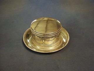 A circular embossed Continental silver biscuit box with hinged lid together with a circular silver dish 17 ozs
