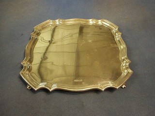 A square silver salver with bracketed border raised on 4 panelled supports, Sheffield 1926 by Walker & Hall 12", 33 ozs