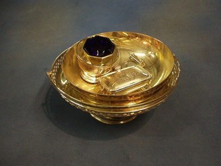 A circular silver plated cake basket with swing handle, raised on a spreading foot, a circular silver plated bowl, do. ashtray, octagonal salt, cigarette box and a magnifying glass
