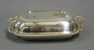 A rectangular silver plated twin handled entree dish and cover