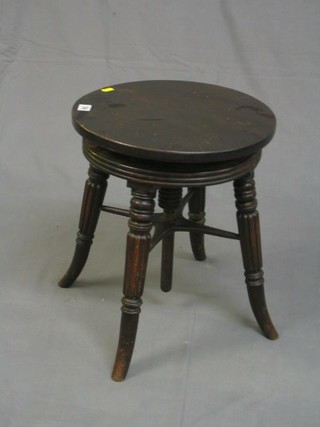 A William IV circular mahogany adjustable piano stool, on turned and reeded supports