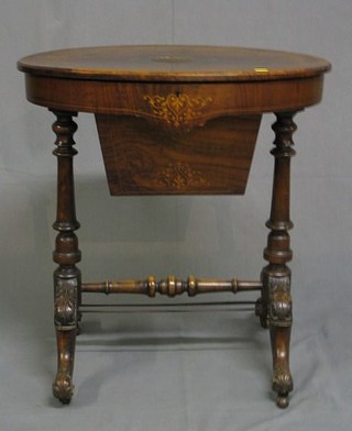 A Victorian oval figured walnutwood inlaid sewing box with hinged lid, the base fitted a deep basket, raised on turned supports with H framed stretcher 26" (damage to top)