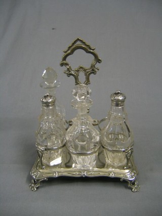 A rectangular silver plated 5 bottle cruet frame with 3 matching cut glass bottles and 1 other (1 bottle missing)