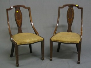 A pair of Edwardian inlaid mahogany slat back nursing chairs with upholstered seats, raised on square tapering supports