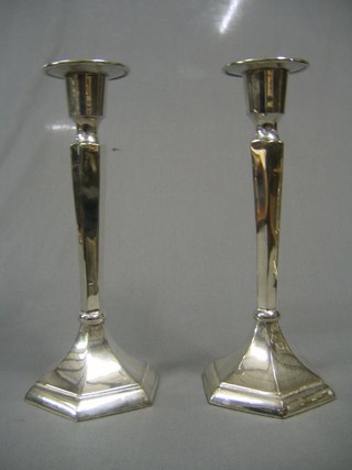 A pair of silver plated candlesticks on octagonal bases 11"