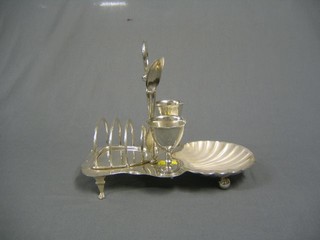 A shaped silver plated egg cruet/toast rack incorporating a butter dish, 3 entree dish handles and a tea strainer