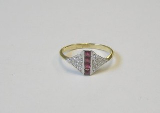 A lady's gold dress ring set 4 square cut rubies supported by diamonds