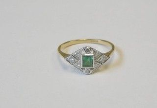 A lady's gold dress ring set a square cut emerald supported by 3 diamonds and numerous smaller diamonds