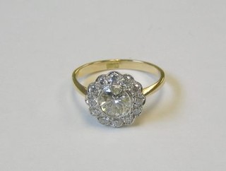 A lady's 18ct gold dress ring set a large circular cut diamond surrounded by 12 diamonds (approx 1.0ct)
