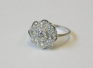 A lady's 18ct white gold floral design dress ring set a central diamond surrounded by diamonds (approx 1.56ct)