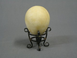 A marble egg on an iron base