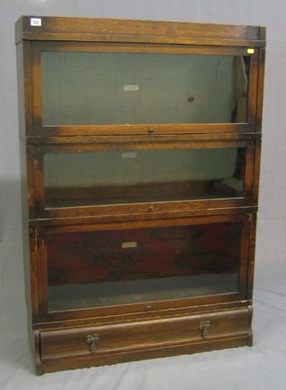 An oak 3 tier Globe Wernicke bookcase, the base fitted a drawer 34"