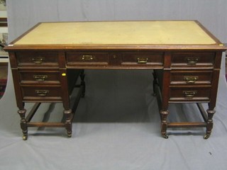 An Edwardian Art Nouveau oak kneehole pedestal desk with inset tooled leather writing surface above 7 drawers, raised on turned and block supports 60"