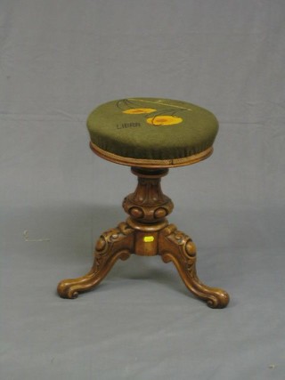 A Victorian carved walnutwood adjustable piano stool