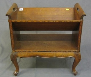 A 19th/20th Century bleached mahogany book trough raised on cabriole supports 24"