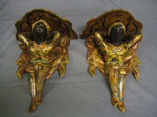 A  handsome pair of fine quality carved wooden Blackamoor wall brackets in the form of crouching Nubians 16"