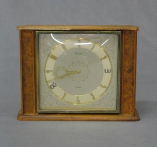 A 1950's 8 day mantel clock with square dial and Arabic numerals contained in a walnutwood case (f)