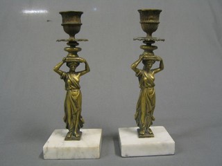A pair of reproduction gilt bronze and marble candlesticks in the form of classical lady's on white marble bases 9"