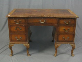 A Chippendale style walnut pedestal kneehole desk with inset tooled leather writing surface, fitted 1 long and 6 short drawers, raised on cabriole supports 48"