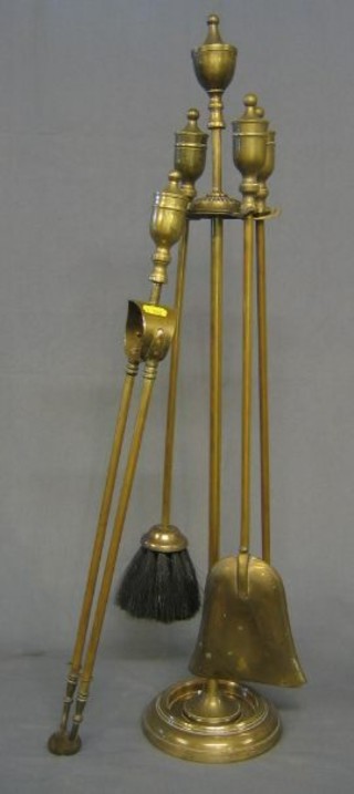 A 19th Century brass fireside companion set