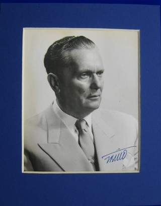 A black and white head and shoulders portrait of Marshall Tito wearing a lounge suit, signed Tito, 6 1/2" x 5 1/2"