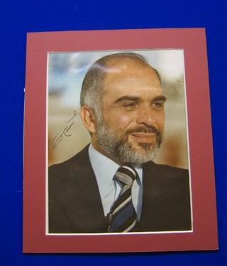 A signed colour portrait photograph of King Hussain of Jordan, 9" x 7"