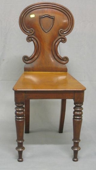 A pair of Victorian mahogany hall chairs with solid seats, on turned supports