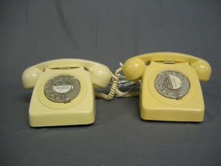 2 cream plastic dial telephones