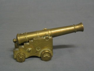 A brass model canon with 5" barrel on a brass trunion