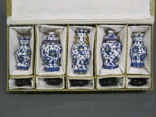 A set of 5 20th Century cloisonne blue and white enamelled porcelain urns 4", cased