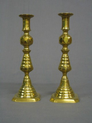 A pair of  19th Century brass candlesticks with knopped stems and ejectors 11" 