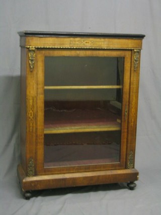 A Victorian walnutwood pier cabinet, the interior fitted adjustable shelves enclosed by glazed panelled  doors, inlaid satinwood stringing and with gilt ormolu mounts 31"