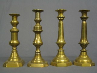 A pair of brass candlesticks with octagonal bases and ejectors 11" and 2 other candlesticks