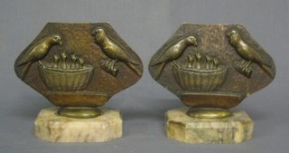 A pair of Art Deco diamond shaped bronze table screens decorated birds, raised on marble bases 7"
