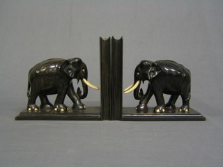 A pair of Eastern hardwood and ivory bookends in the form of elephants