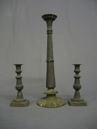 A pair of 19th Century brass candlesticks with ejectors 9" and a large brass candlestick 18"