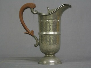 An Art Nouveau planished pewter hot water ewer with beech handle by Evans & Matthews Birmingham, the base marked 2018, 9"