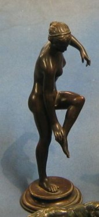 After the antique, a bronze figure of a naked classical lady, raised on a circular base 10"