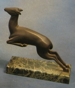 An Art Deco bronze figure of a leaping gazelle, raised on a green veined marble base 8"