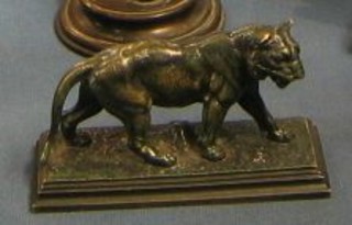 J Maigneieg, a bronze figure of a walking lion, on a square naturalistic base 5"