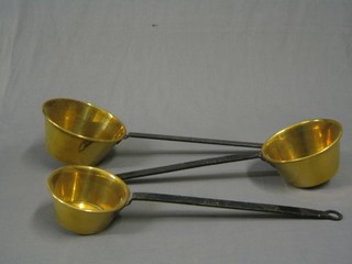 3 graduated brass saucepans with iron handles