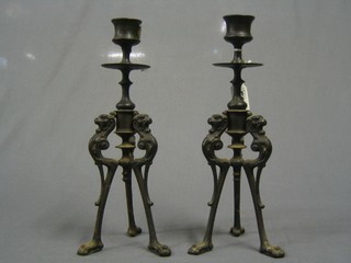 A pair of 19th Century bronze candlesticks decorated griffins 10"