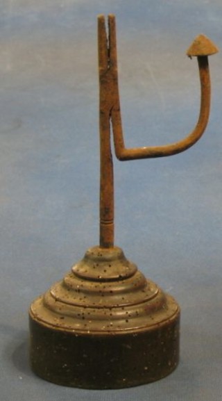 An antique iron rush light holder