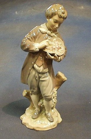 A 1972 Lladro figure of a standing boy with bowl of fruit, base incised 61048 issue no. 01004757 11"