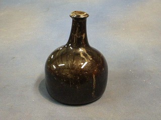 An antique black glass mallet shaped wine bottle 8"