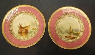 A pair of 19th Century circular Minton? porcelain plates decorated lake with fishing  boat and mountain lake with Church, pink and gilt banding 9"