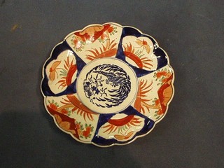A circular 19th Century Japanese Imari porcelain plate with panel decoration the central panel decorated a mythical bird 8"