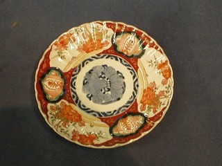A 19th Century Japanese Imari porcelain plate, the centre decorated a flower head 9"