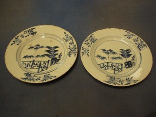 A pair of 18th Century Oriental blue and white porcelain plates decorated a fence and trees 9"