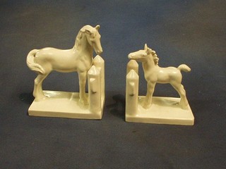 A pair of Goebal? white glazed pottery bookends in the form of horses at fences, the base incised XS 103B and A